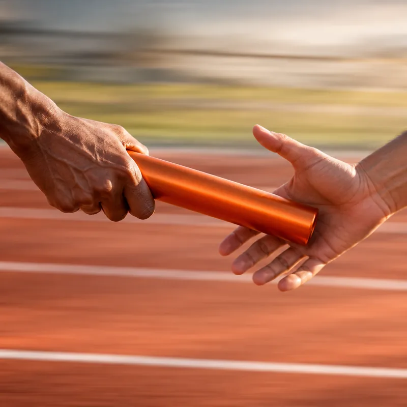 Relay baton passed between two hands